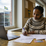 Person preparing a Swedish citizenship application with official documents